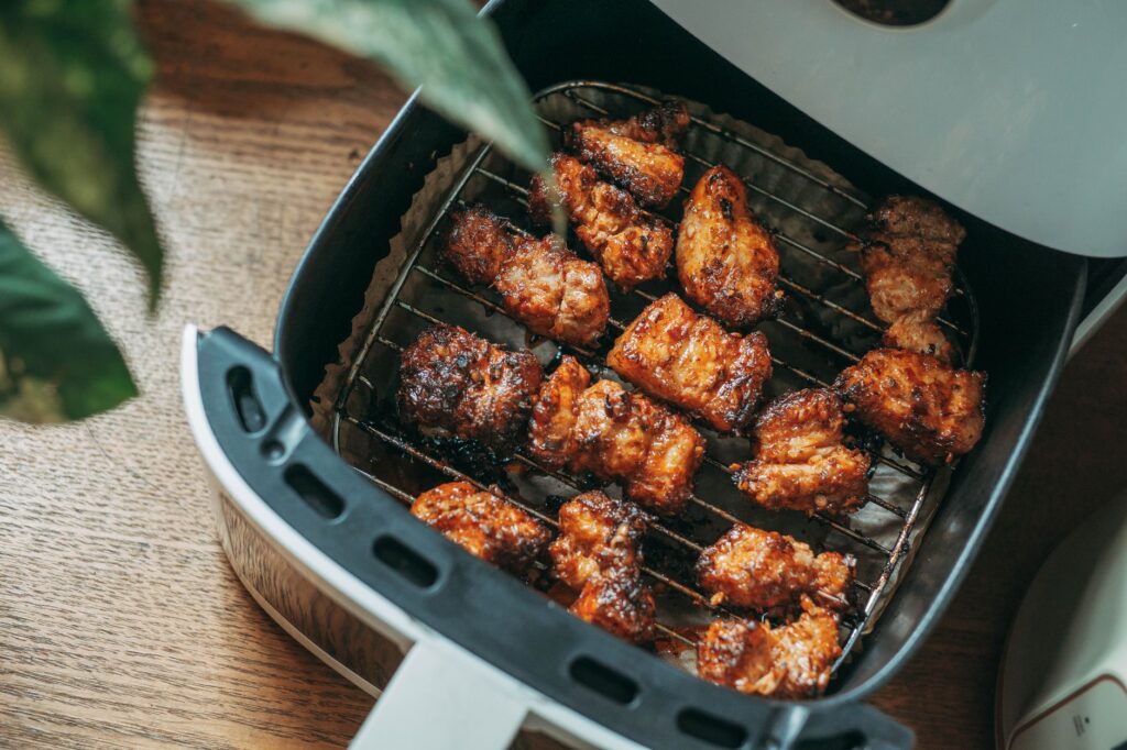 Golden chicken bites in an air fryer basket