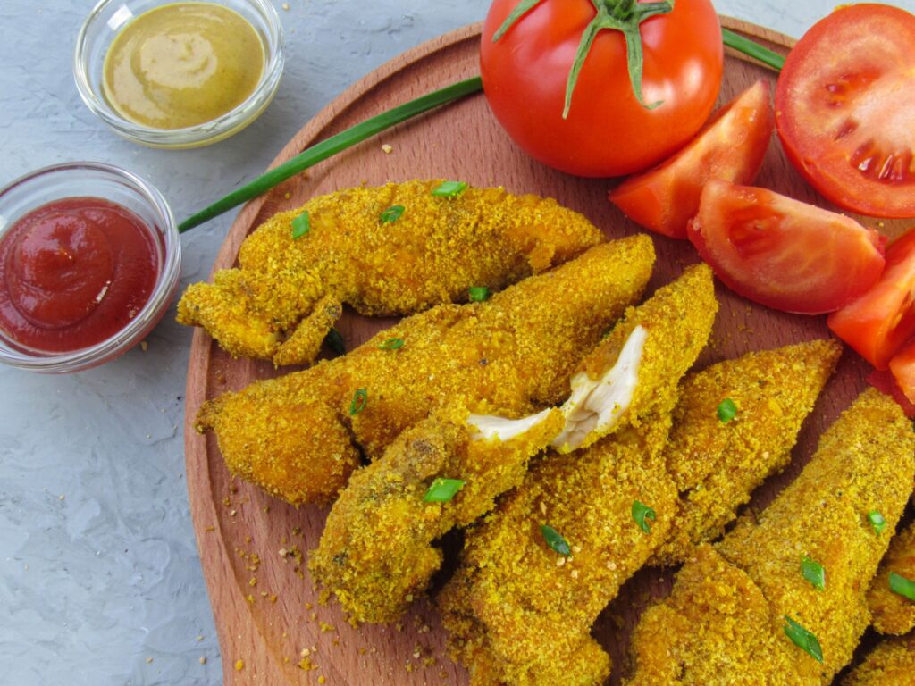 Air fryer chicken tenders for one served with dipping sauces.