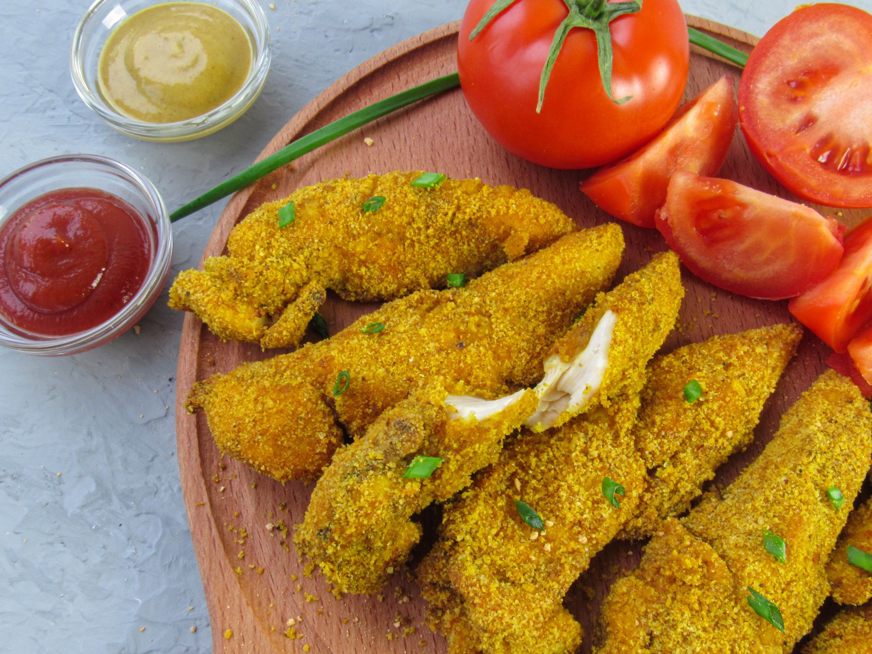 Air fryer chicken tenders for one served with dipping sauces.