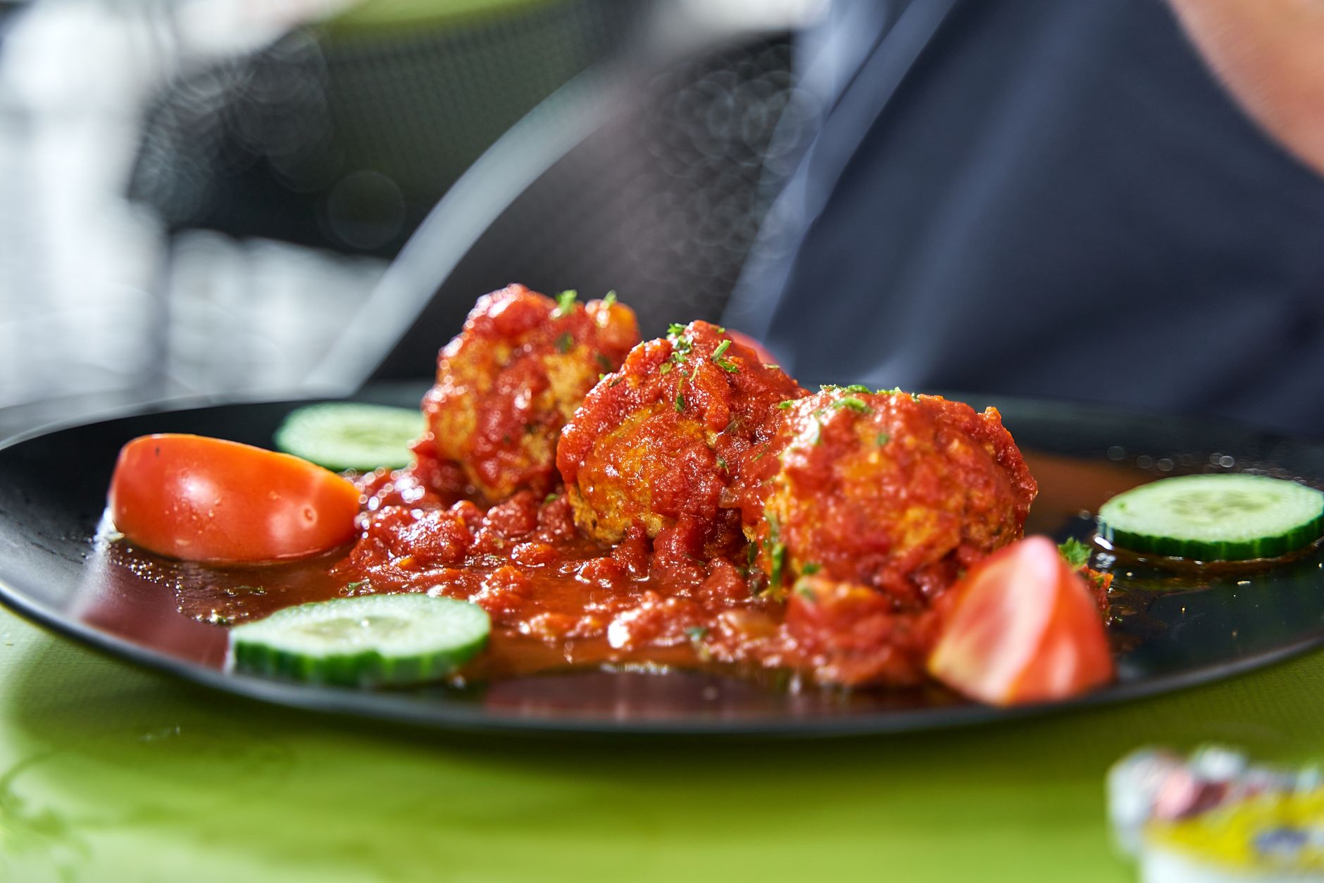 Air fryer meatballs for one served with tomato sauce.
