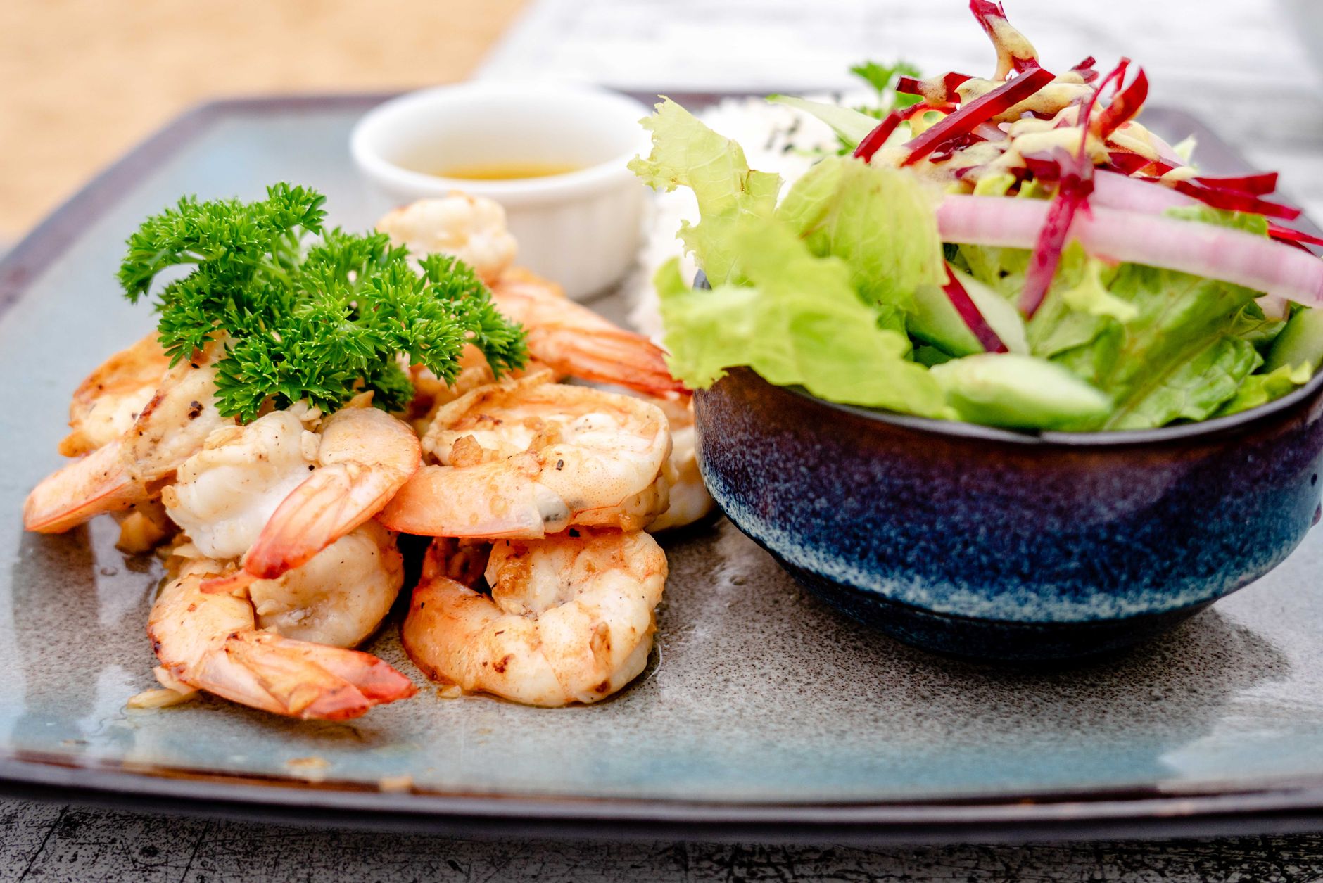 Air fryer shrimp for one served with a simple green salad.