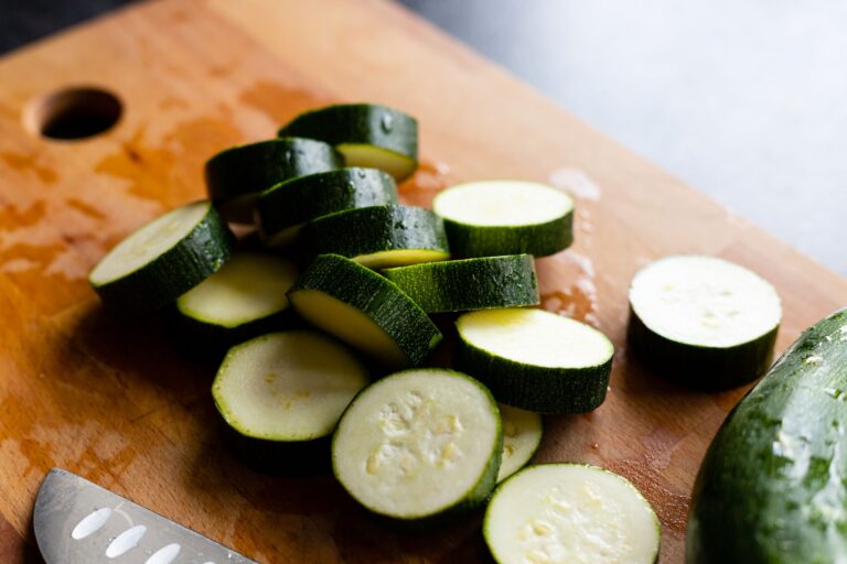 Air fryer zucchini fries for one ingredient prep: raw zucchini slices on a cutting board before being cut into sticks.