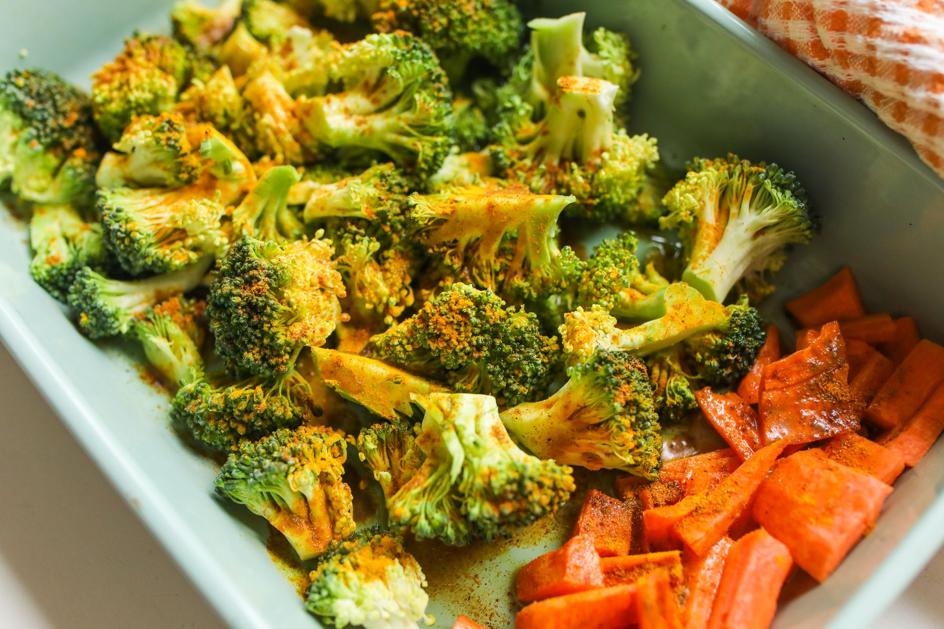 Air fryer broccoli for one prep inspiration: seasoned broccoli florets with carrots in a serving dish.
