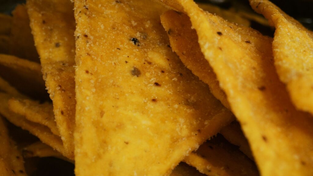 Tortilla chips for air fryer nachos for one, shown before adding beans, cheese and toppings.